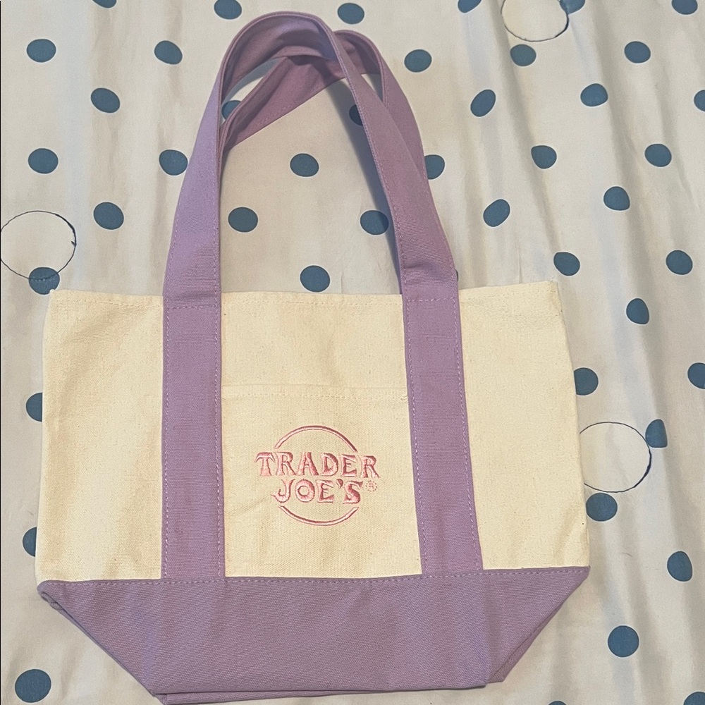 Trader Joe’s Purple and Cream Tote Bag Never used. Tag on purple not on but new.